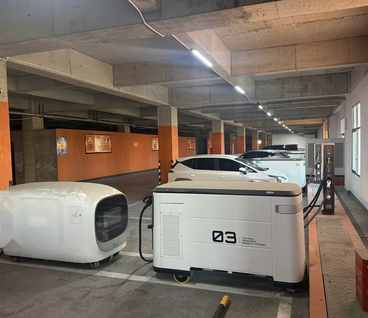 mobile storage EV charger serving vehicles in a commercial parking lot - no grid upgrade needed
