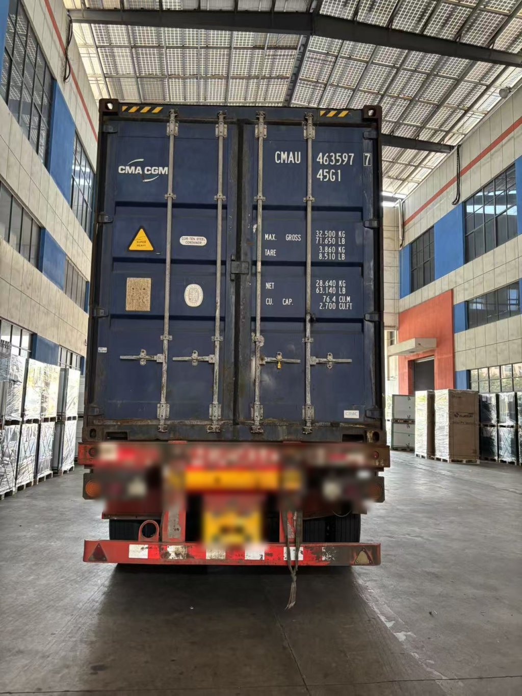 Container truck departing with a consolidated solar and storage shipment