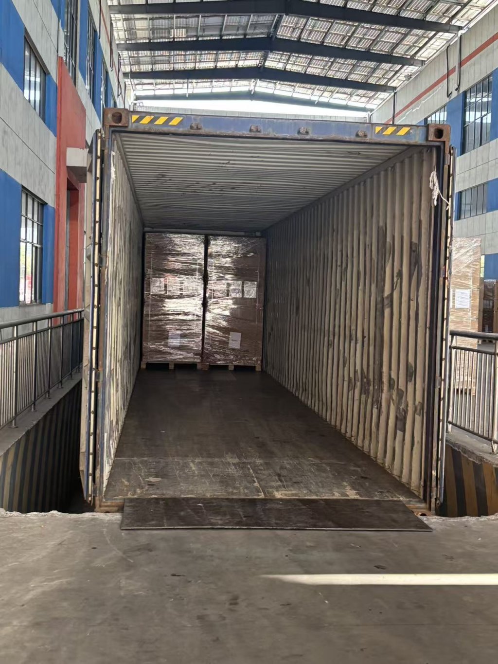 Solar modules being loaded into a shipping container for export shipment